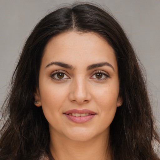Joyful white young-adult female with long  brown hair and brown eyes