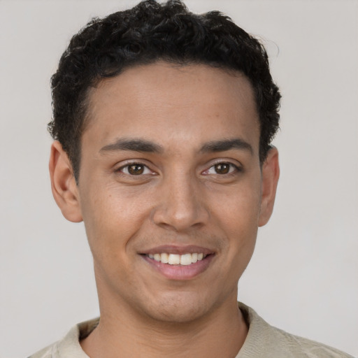 Joyful white young-adult male with short  black hair and brown eyes