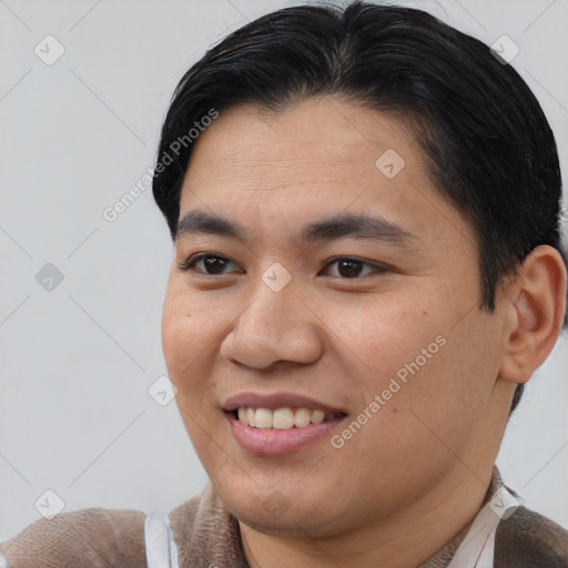 Joyful asian young-adult male with short  brown hair and brown eyes