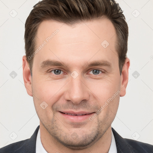 Joyful white young-adult male with short  brown hair and grey eyes