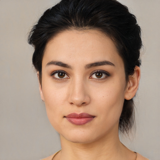 Joyful latino young-adult female with medium  brown hair and brown eyes