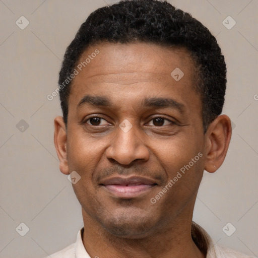 Joyful latino adult male with short  black hair and brown eyes