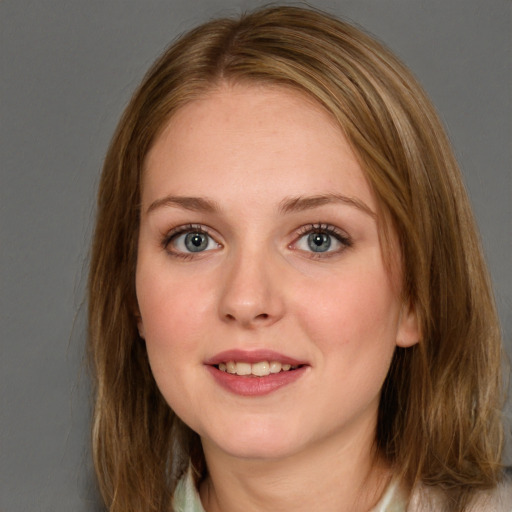 Joyful white young-adult female with long  brown hair and blue eyes