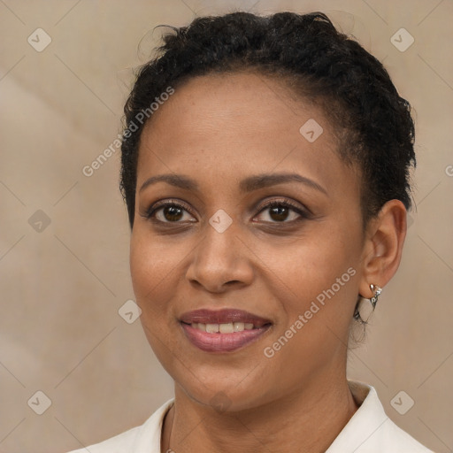 Joyful black young-adult female with short  brown hair and brown eyes