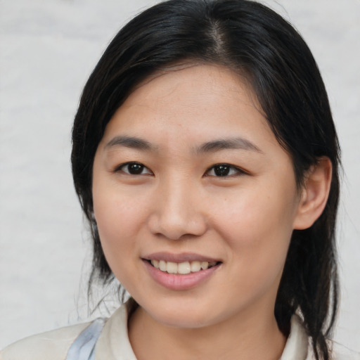 Joyful asian young-adult female with medium  brown hair and brown eyes