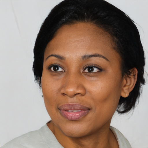 Joyful black young-adult female with medium  black hair and brown eyes