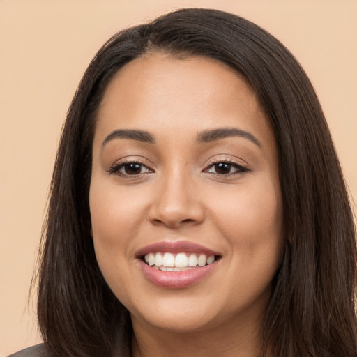 Joyful white young-adult female with long  brown hair and brown eyes