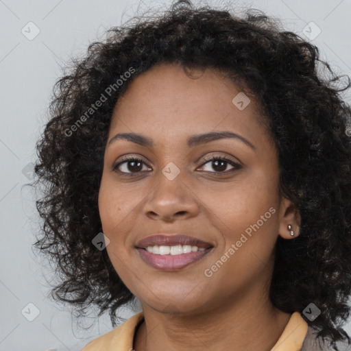 Joyful black young-adult female with long  brown hair and brown eyes