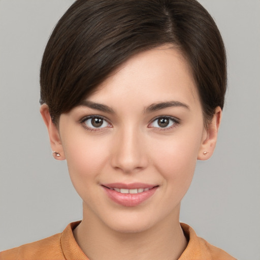 Joyful white young-adult female with short  brown hair and brown eyes