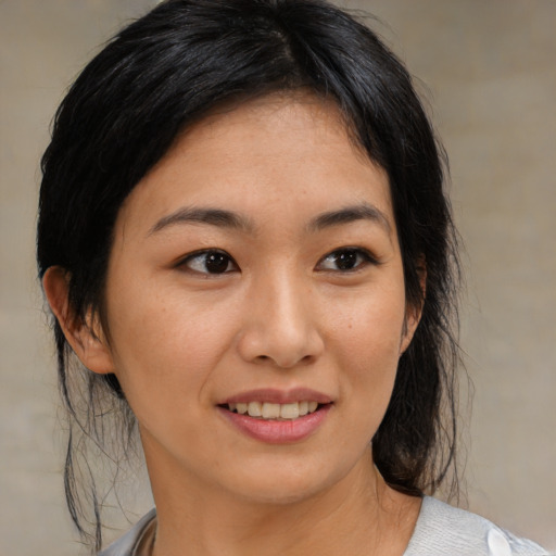 Joyful asian young-adult female with medium  black hair and brown eyes