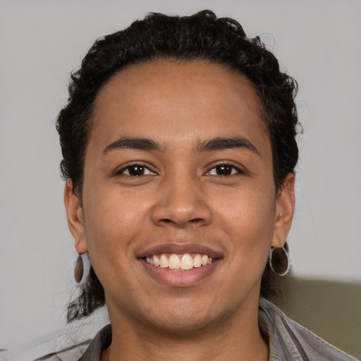 Joyful latino young-adult male with short  brown hair and brown eyes