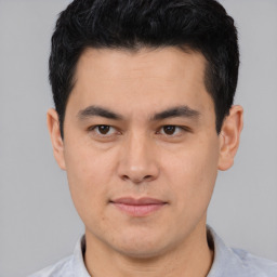 Joyful asian young-adult male with short  black hair and brown eyes