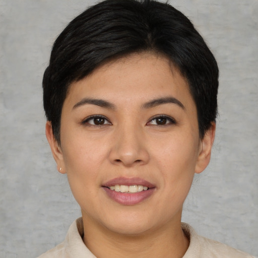 Joyful asian young-adult female with short  black hair and brown eyes