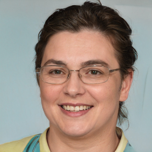 Joyful white adult female with short  brown hair and blue eyes