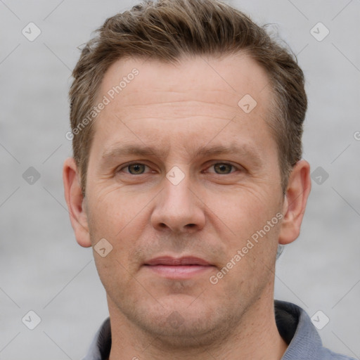 Joyful white adult male with short  brown hair and grey eyes