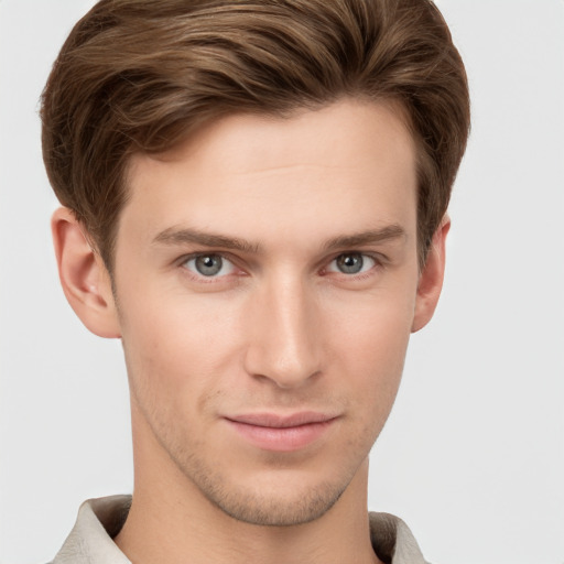 Joyful white young-adult male with short  brown hair and grey eyes