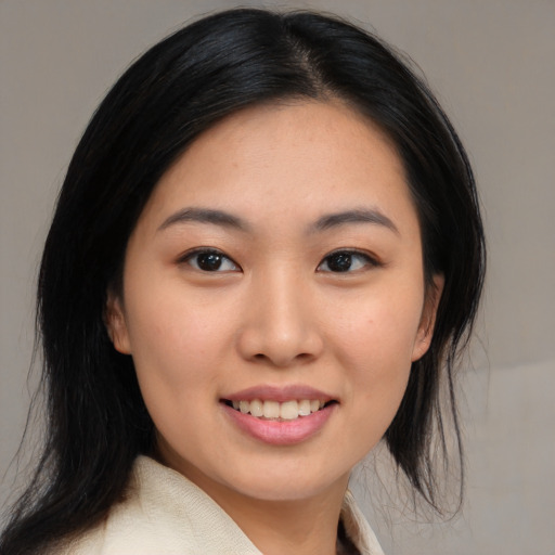 Joyful asian young-adult female with medium  black hair and brown eyes