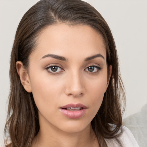 Neutral white young-adult female with long  brown hair and brown eyes