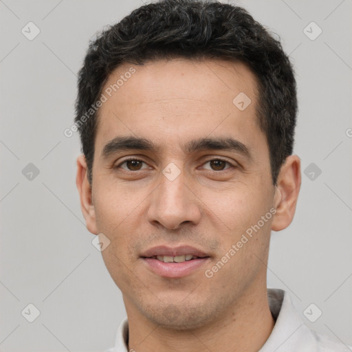 Joyful white young-adult male with short  black hair and brown eyes