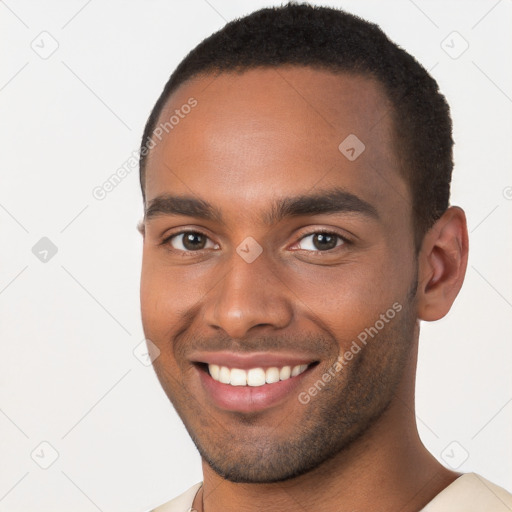 Joyful black young-adult male with short  brown hair and brown eyes