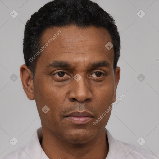 Neutral latino adult male with short  black hair and brown eyes