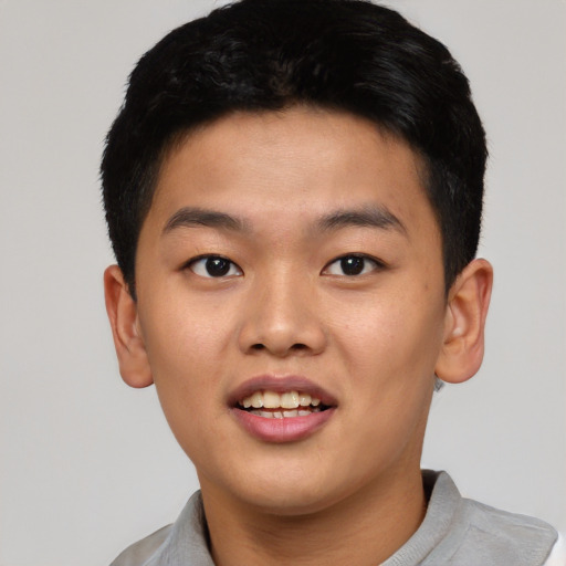 Joyful asian young-adult male with short  brown hair and brown eyes