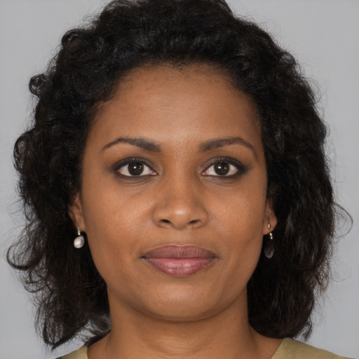 Joyful black young-adult female with medium  brown hair and brown eyes