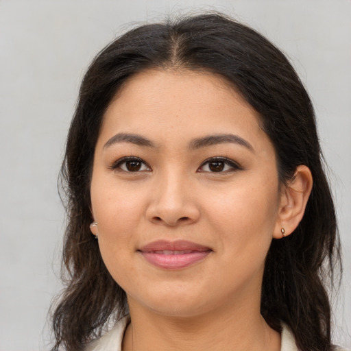 Joyful white young-adult female with long  brown hair and brown eyes