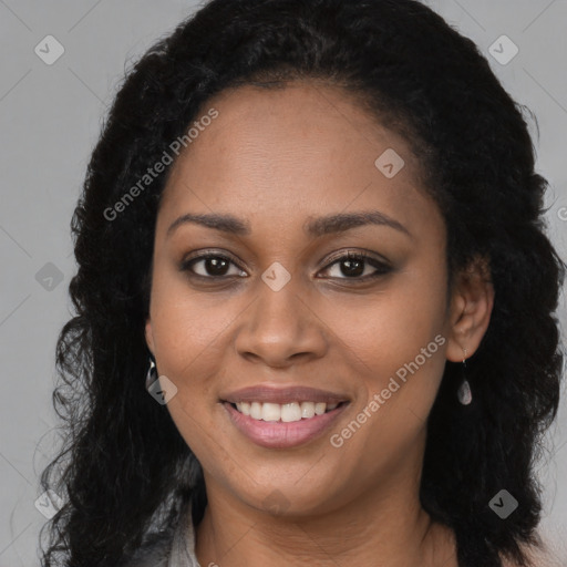 Joyful black young-adult female with long  brown hair and brown eyes