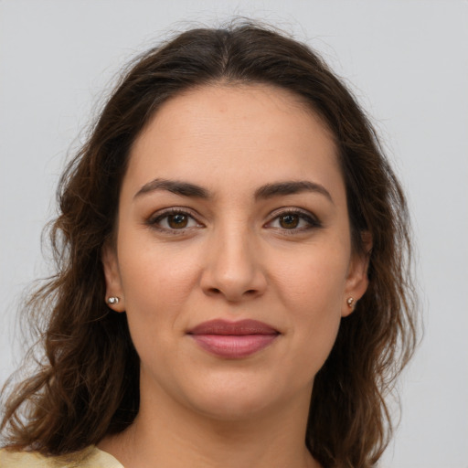 Joyful white young-adult female with medium  brown hair and brown eyes