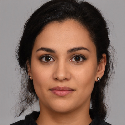 Joyful latino young-adult female with long  brown hair and brown eyes