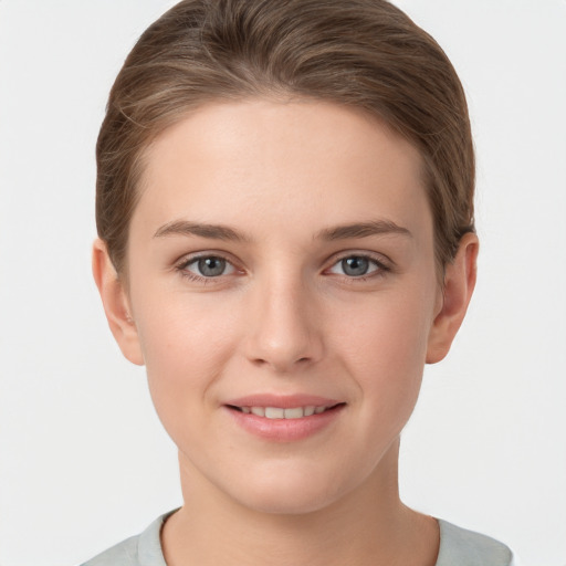 Joyful white young-adult female with short  brown hair and grey eyes