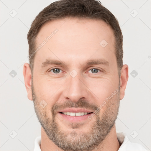 Joyful white adult male with short  brown hair and brown eyes