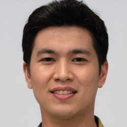 Joyful asian young-adult male with short  brown hair and brown eyes