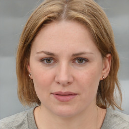 Joyful white young-adult female with medium  brown hair and blue eyes