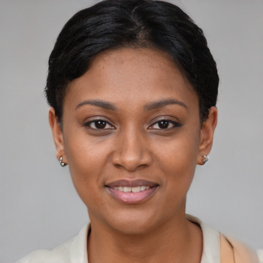Joyful black young-adult female with short  black hair and brown eyes