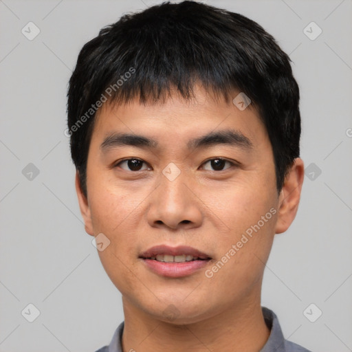 Joyful asian young-adult male with short  black hair and brown eyes