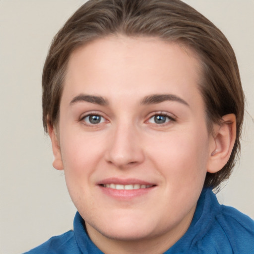 Joyful white young-adult female with medium  brown hair and blue eyes