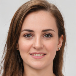 Joyful white young-adult female with long  brown hair and green eyes