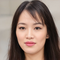 Joyful asian young-adult female with long  brown hair and brown eyes