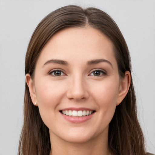 Joyful white young-adult female with long  brown hair and grey eyes