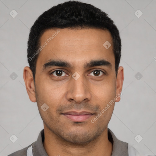 Joyful latino young-adult male with short  black hair and brown eyes