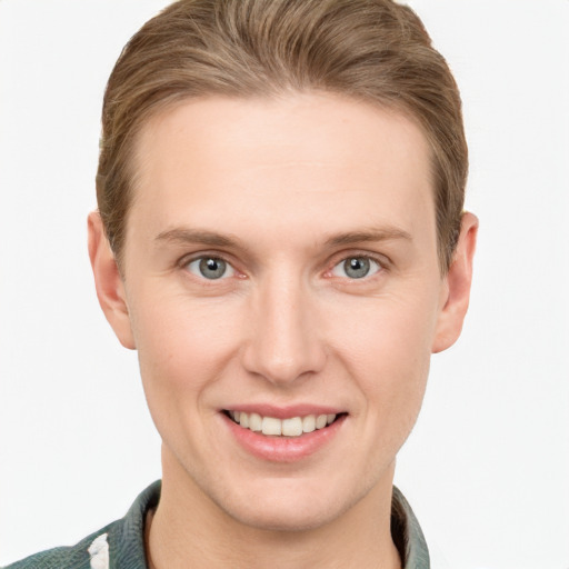 Joyful white young-adult male with short  brown hair and grey eyes