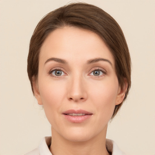 Joyful white young-adult female with medium  brown hair and grey eyes