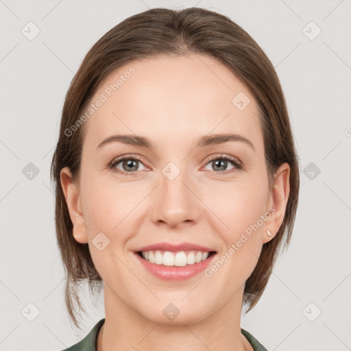 Joyful white young-adult female with medium  brown hair and grey eyes