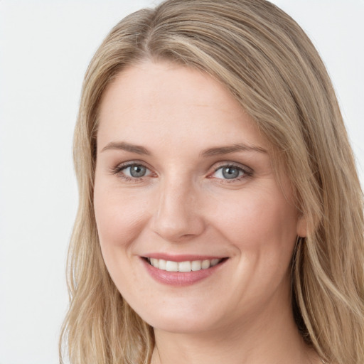 Joyful white young-adult female with long  brown hair and blue eyes