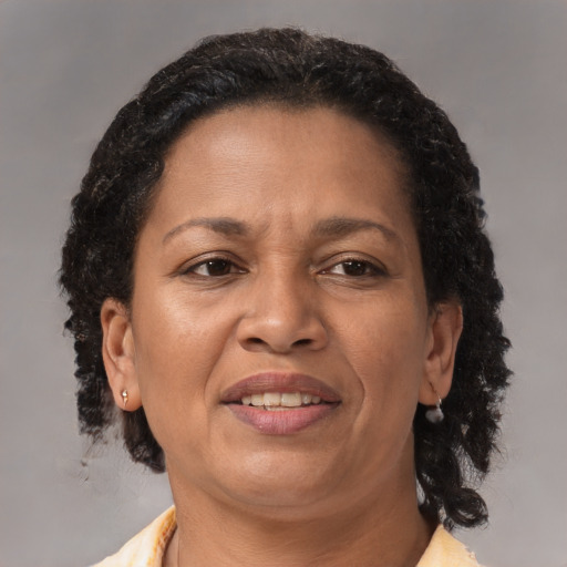 Joyful latino adult female with medium  brown hair and brown eyes