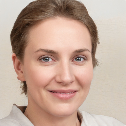 Joyful white young-adult female with medium  brown hair and grey eyes