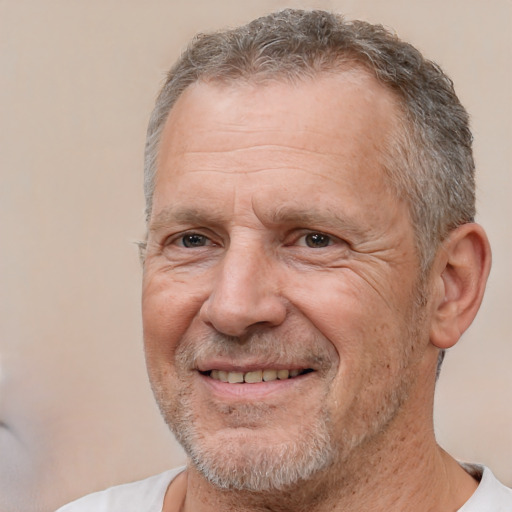 Joyful white middle-aged male with short  gray hair and brown eyes