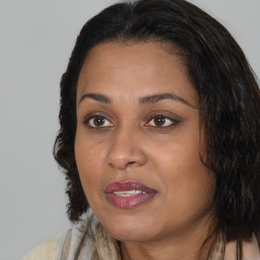 Joyful black adult female with medium  brown hair and brown eyes